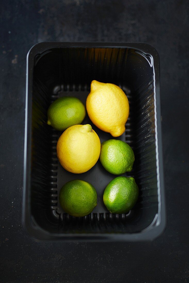 Limes and lemons in a tray