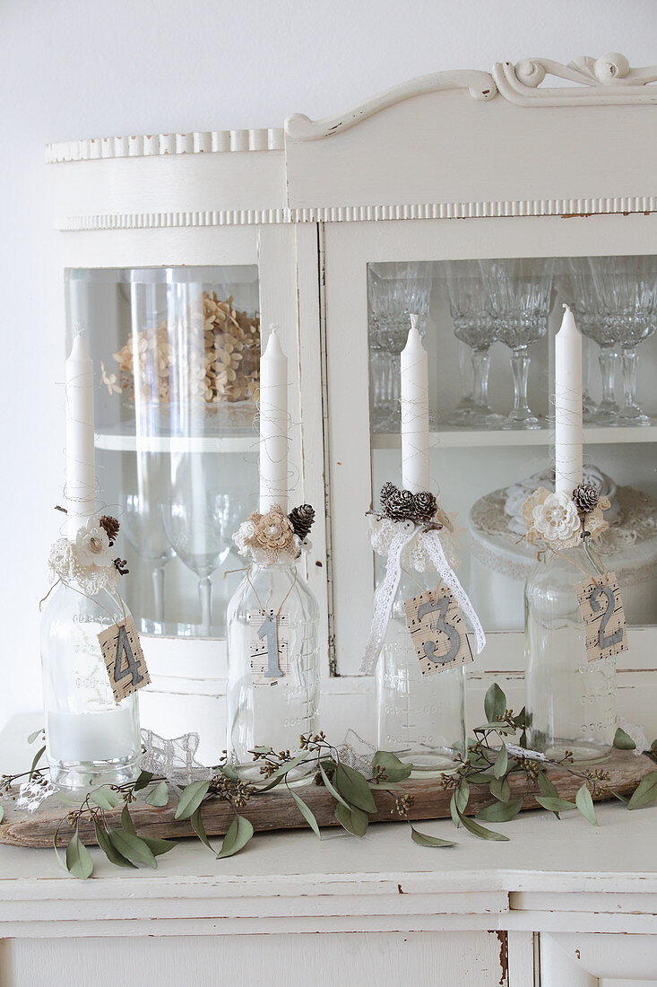 Four bottles in numbered bottles on old dresser