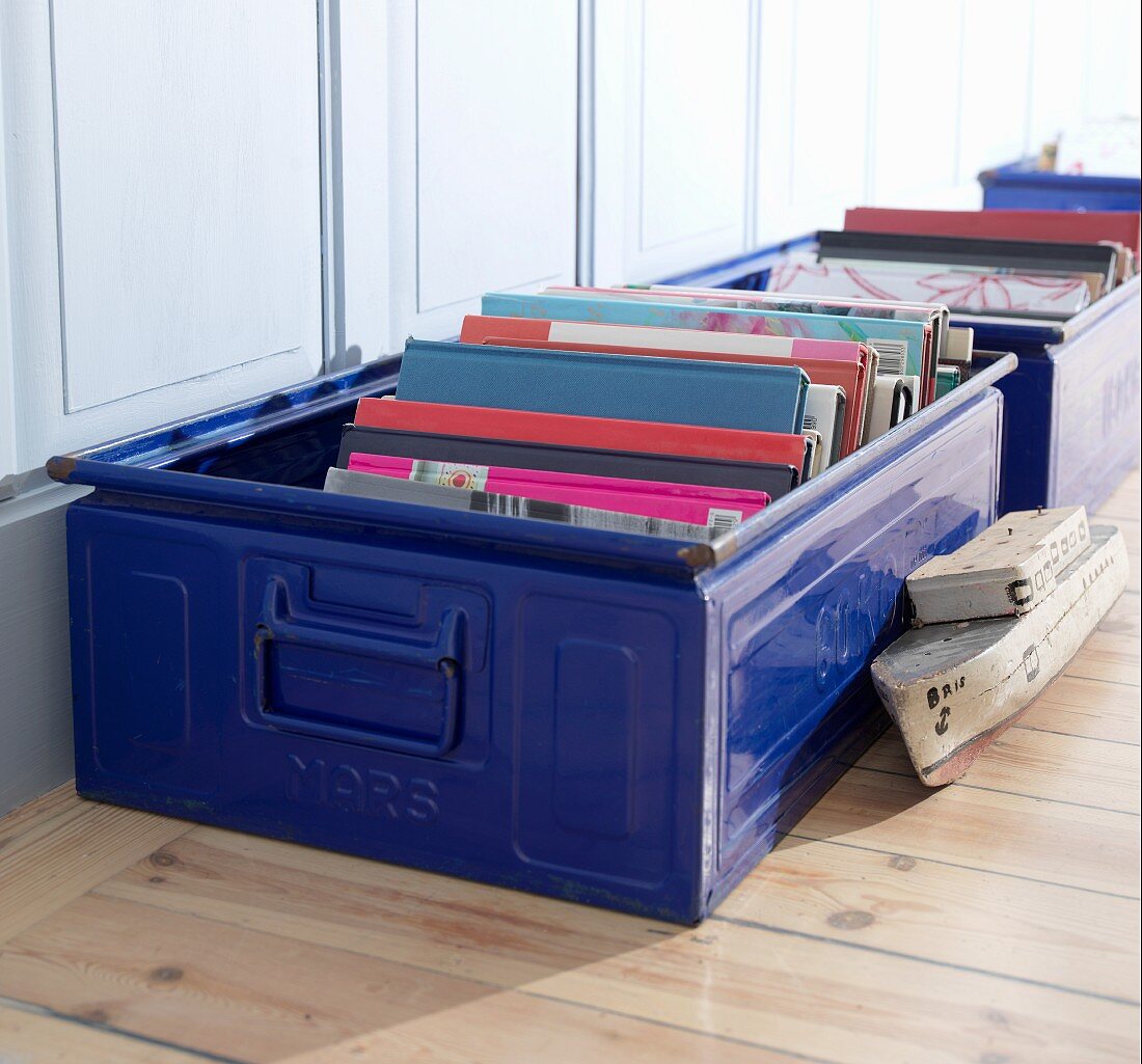 Books stored in blue metal cases