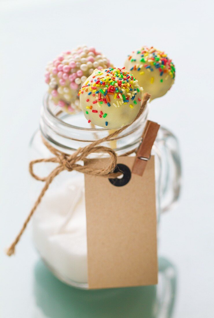 Cake pops with a white chocolate glaze and sugar beads