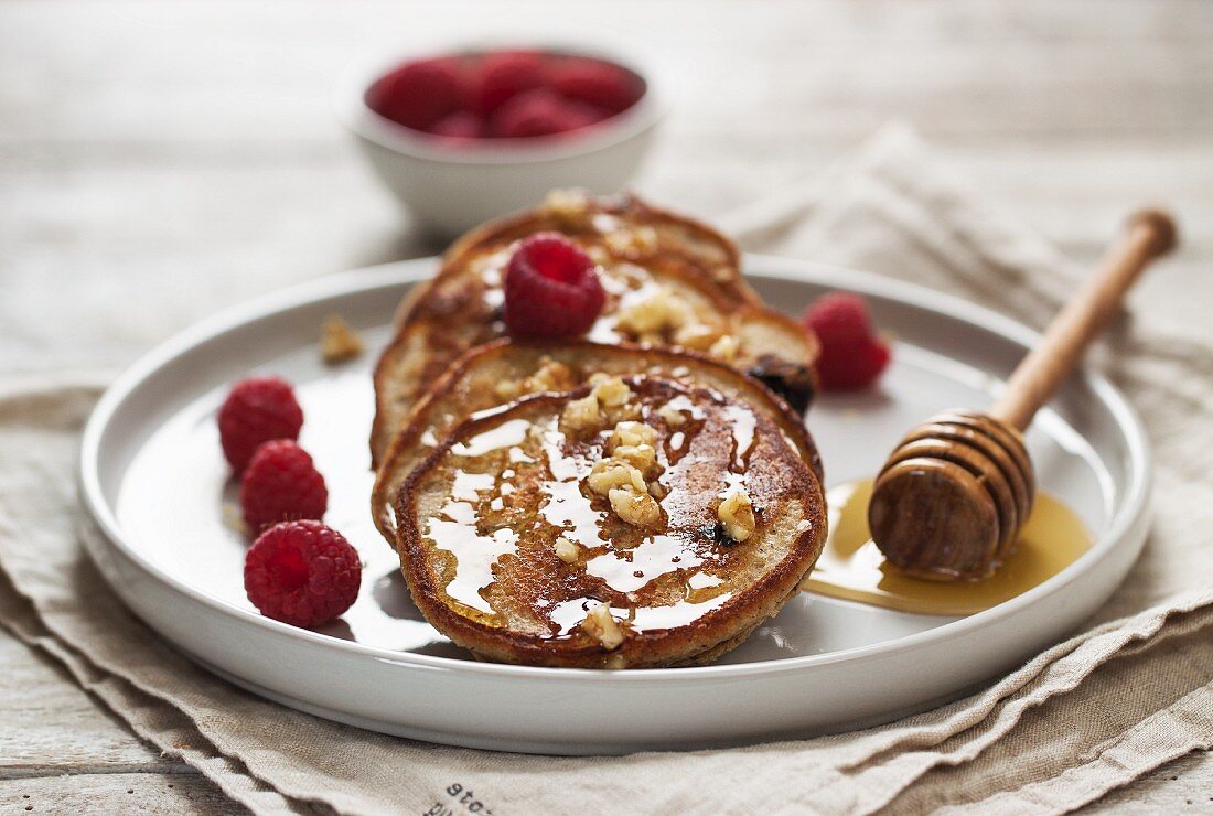 Quark and buckwheat pancakes with blueberries, raspberries and a honey nut topping