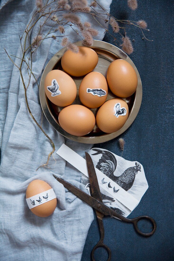 Vintage scissors and Easter eggs decorated with animal stickers