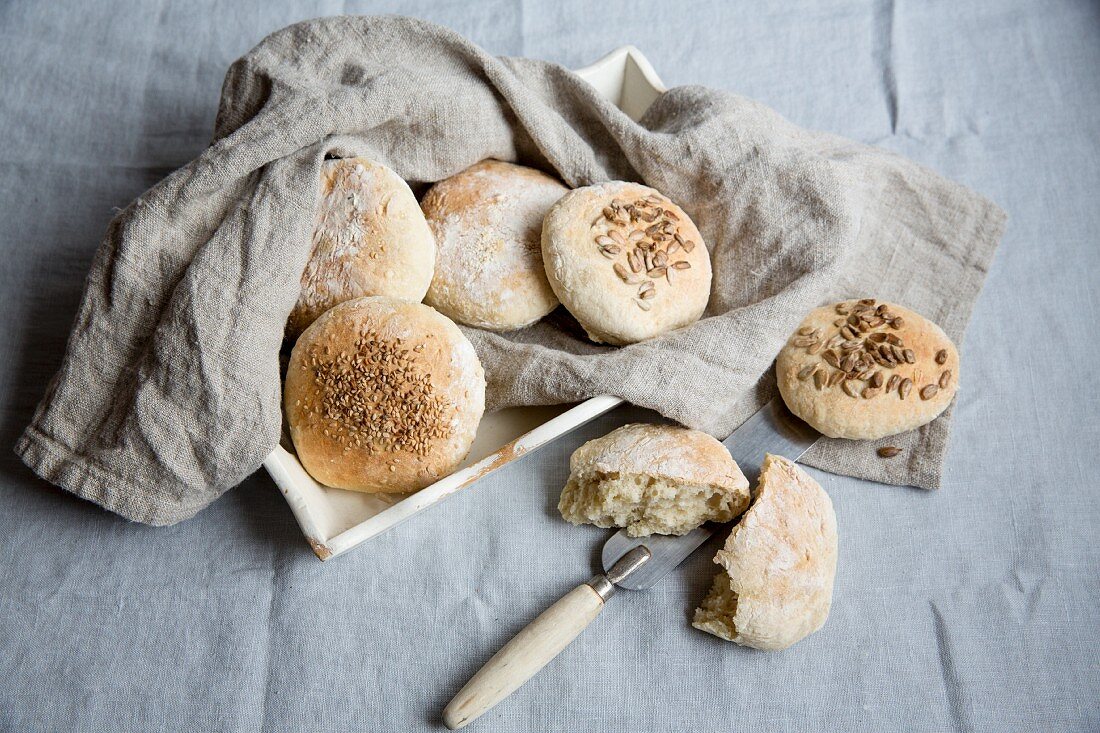 Spelt bread rolls on a linen cloth