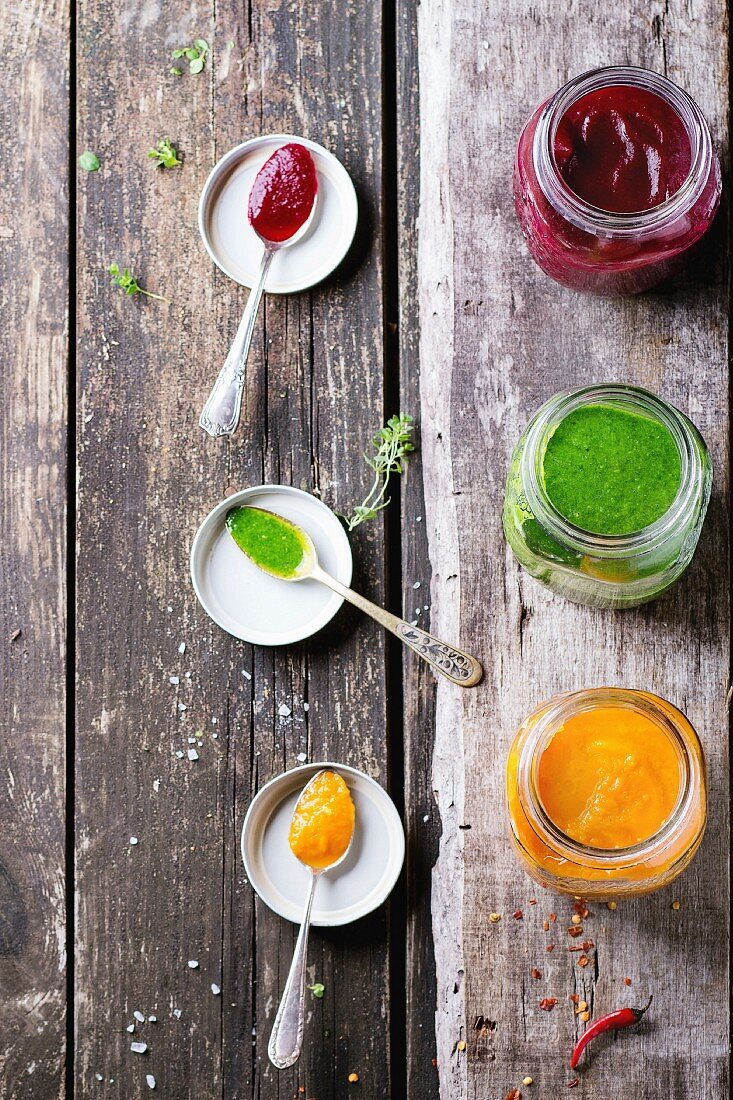 Assortment of vegetable smoothies from carrot, beetroot and spinach in glass jars