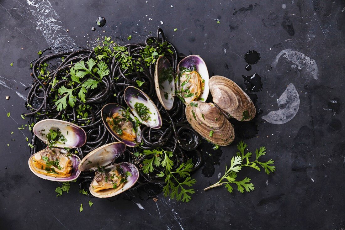 Seafood pasta with clams Spaghetti Vongole on dark marble background