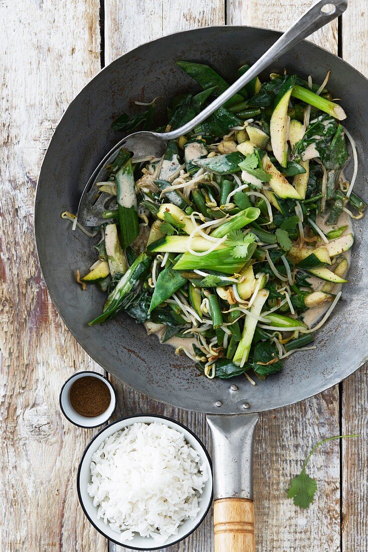 Green stir fried vegetables with a rice garnish