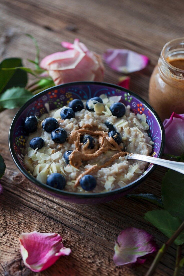 Porridge, blueberries and almond butter for healthy breakfast