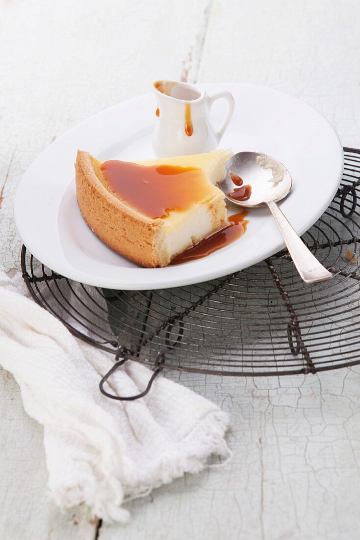 Classical Cheesecake and caramel Sauce on plate on blue texture background