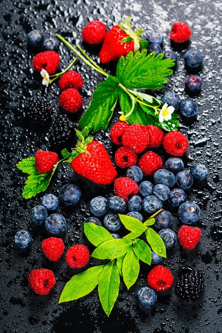Fresh Berries on Dark Background: Strawberries, Raspberries and Blueberries