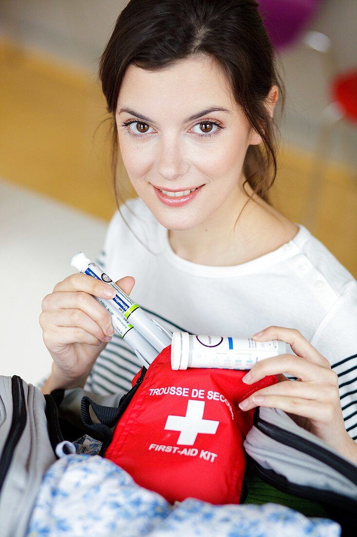 Woman preparing first aid kit