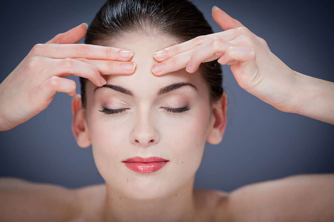 Woman massaging forehead