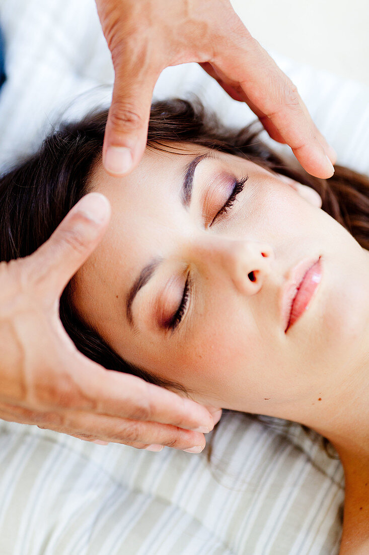 Woman receiving Reiki treatment