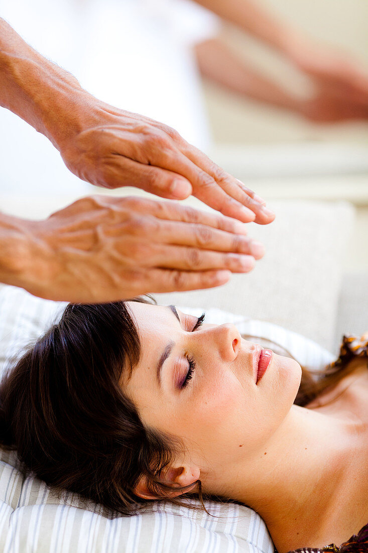 Woman receiving Reiki treatment