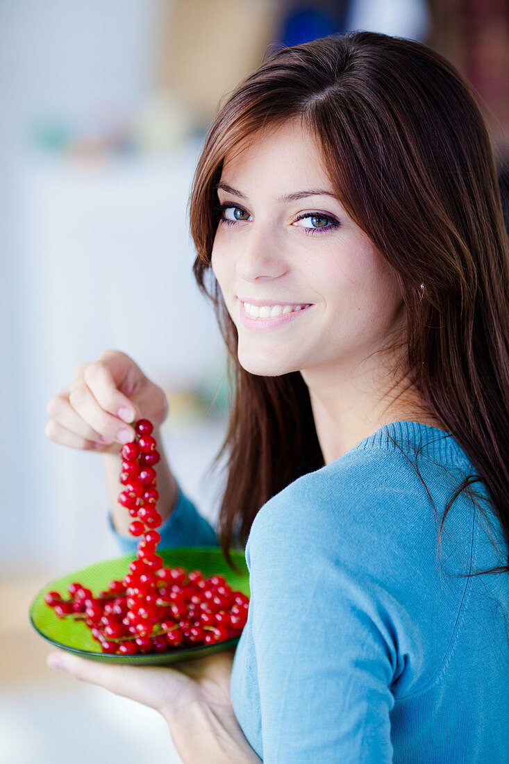 Woman eating red currants