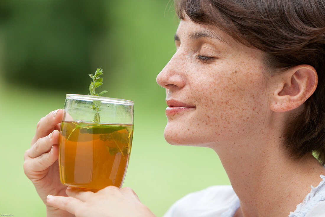 Woman drinking herbal infusion