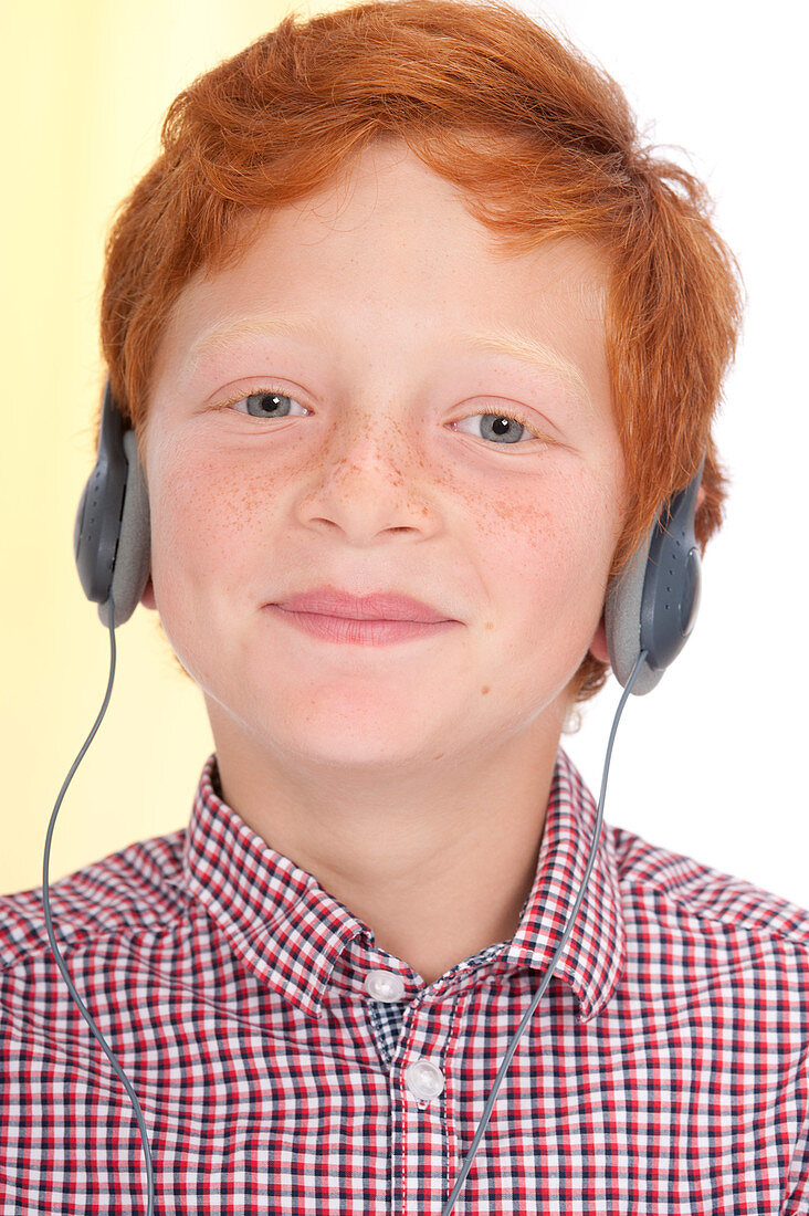Boy wearing headphones smiling