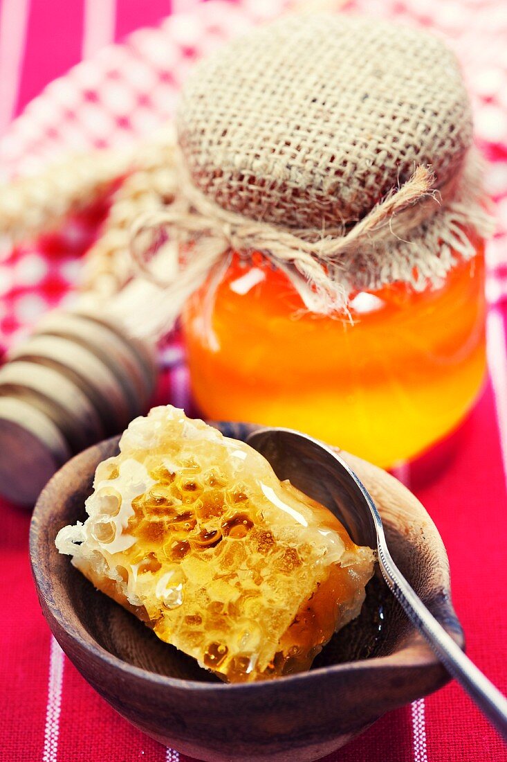 Beautiful honey comb, spoon and honey in jar