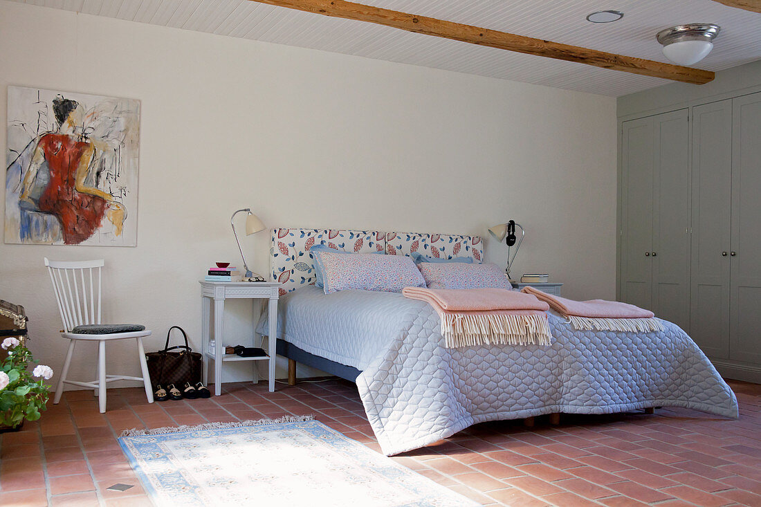 Rustic bedroom with terracotta floor tiles