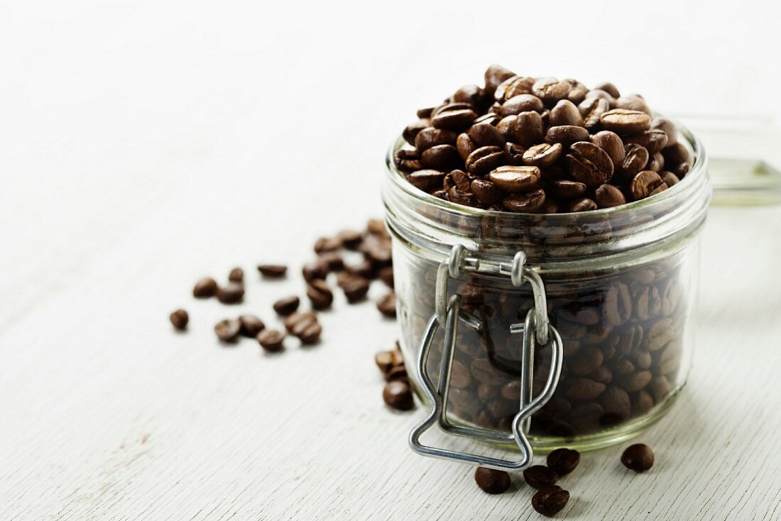 Large glass jar full of coffee beans