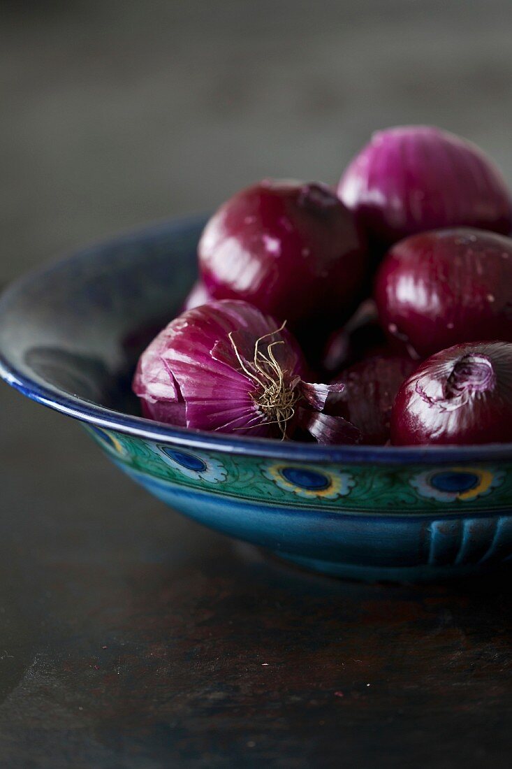 Peeled red onions in a bowl
