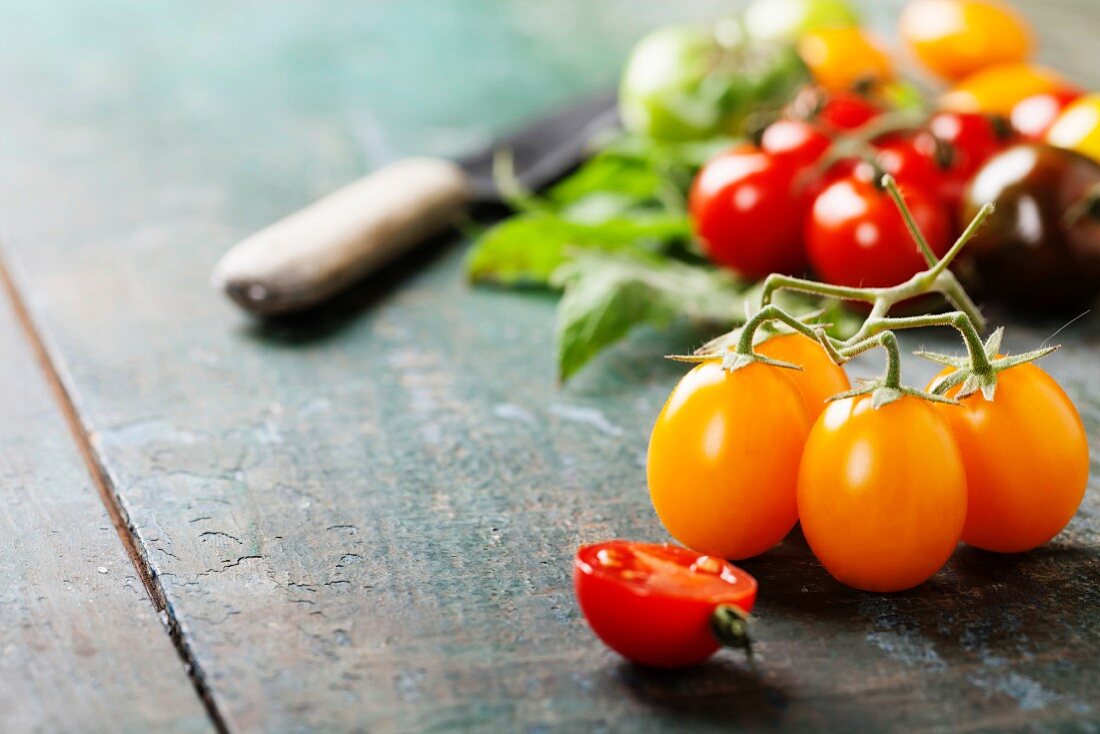 various of colorful tomatoes on wooden background