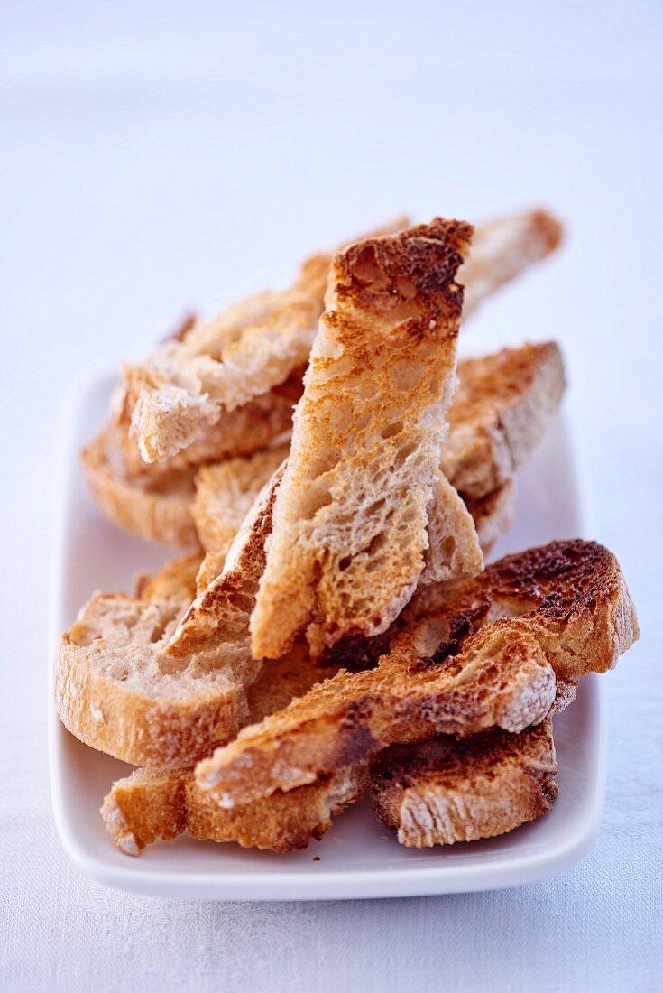 Toasted bread strips on a plate