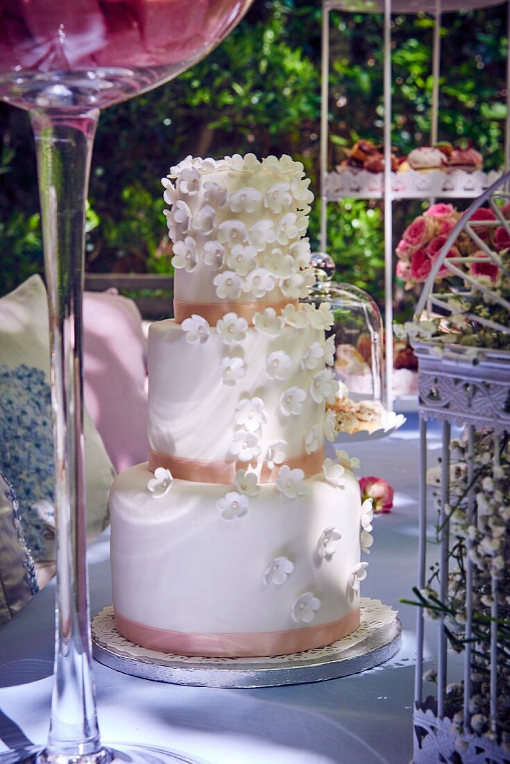 Three tier wedding cake on a garden table