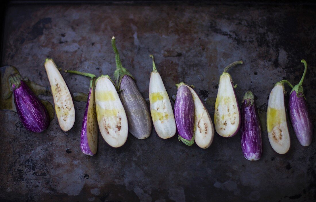 Fairytale Eggplants, Halved on Dark Pan