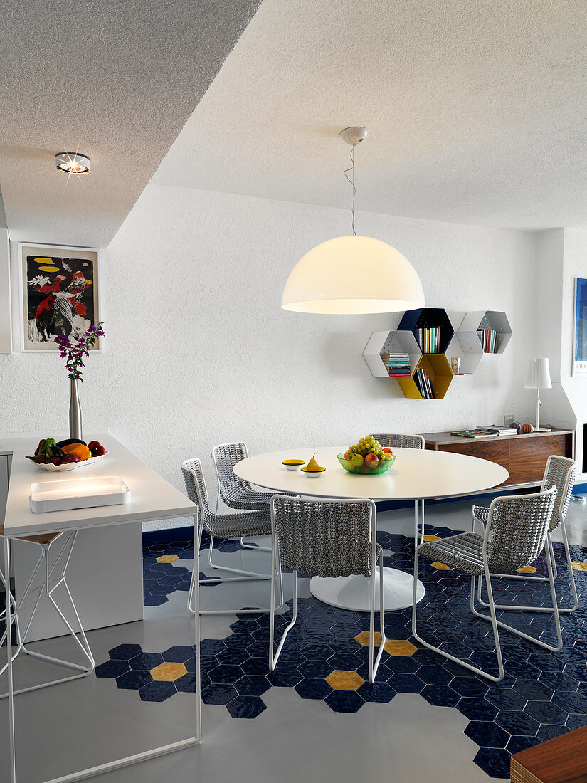 Open-plan kitchen and dining room with blue hexagonal floor tiles