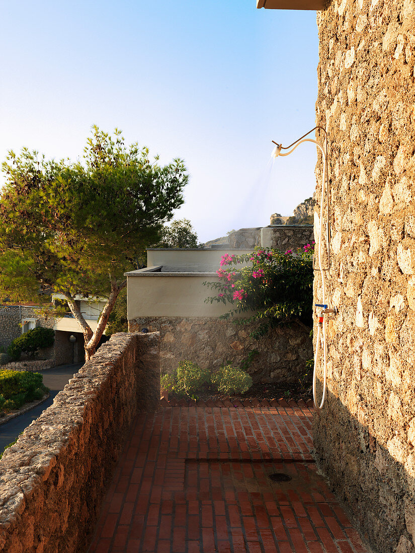 Outdoor shower on stone wall of Mediterranean house