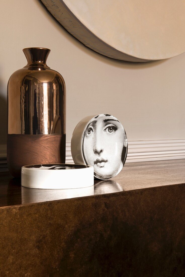 Fornasetti plate and bronze vase