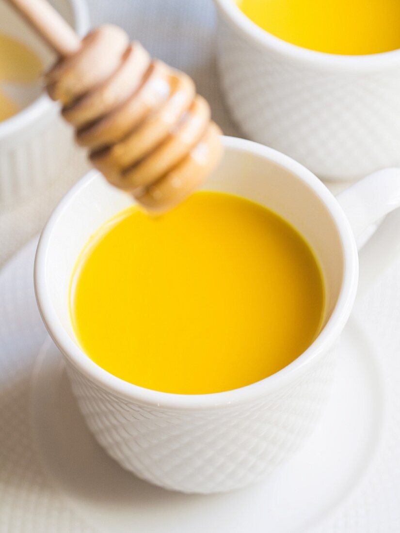 Homemade golden milk with honey