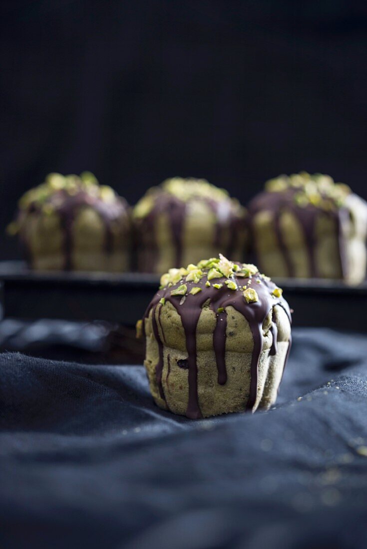 Vegan matcha muffins with chocolate and chopped pistachios