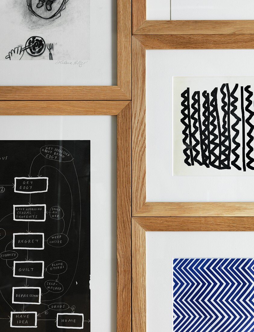 Various drawings in wooden frames on wall