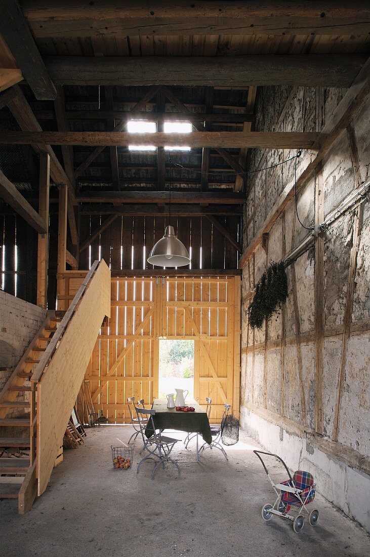 Garden table and chairs in gloomy old barn