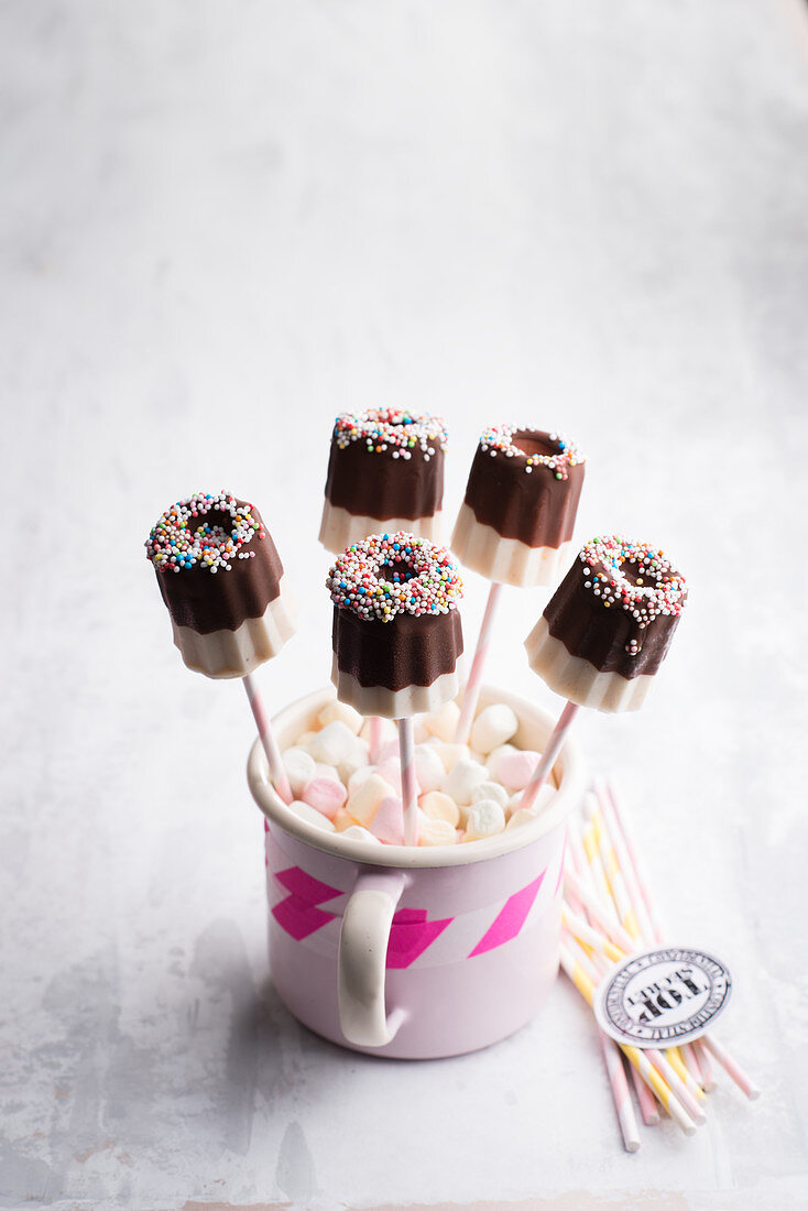 Apricot ice pops with chocolate glaze and sugar pearls