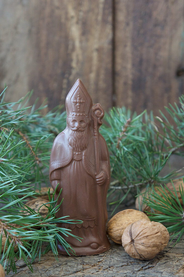 A homemade chocolate Santa Claus next to nuts