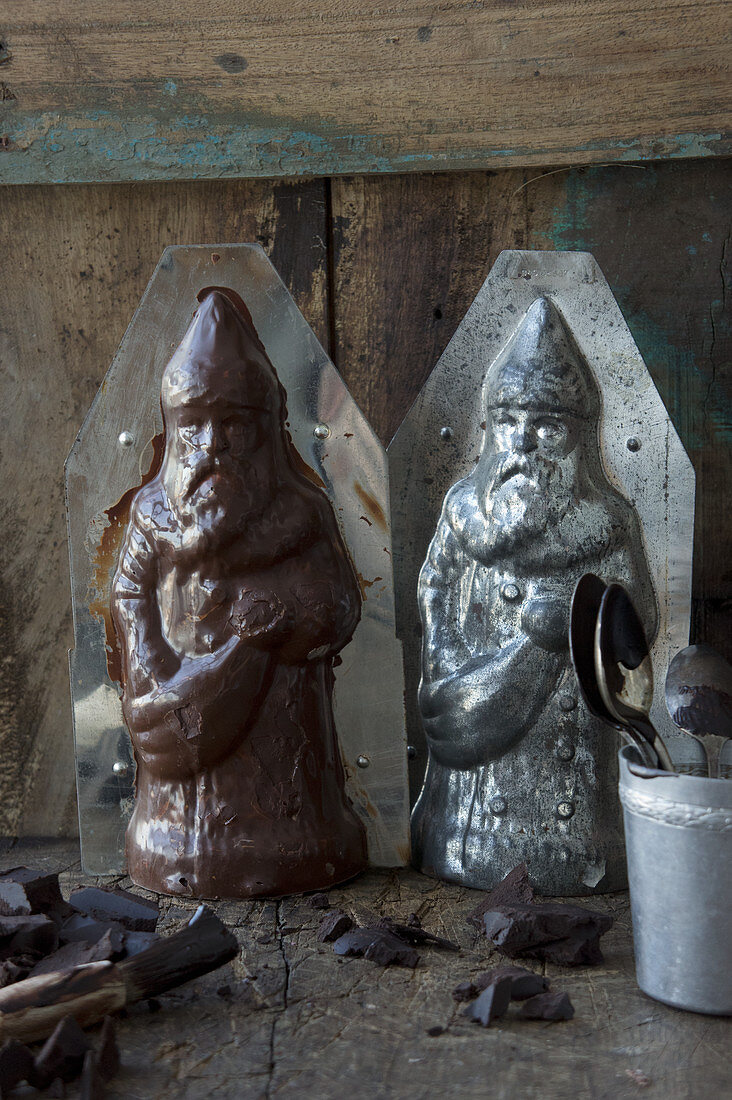 A homemade chocolate Santa Claus next to the plastic mould
