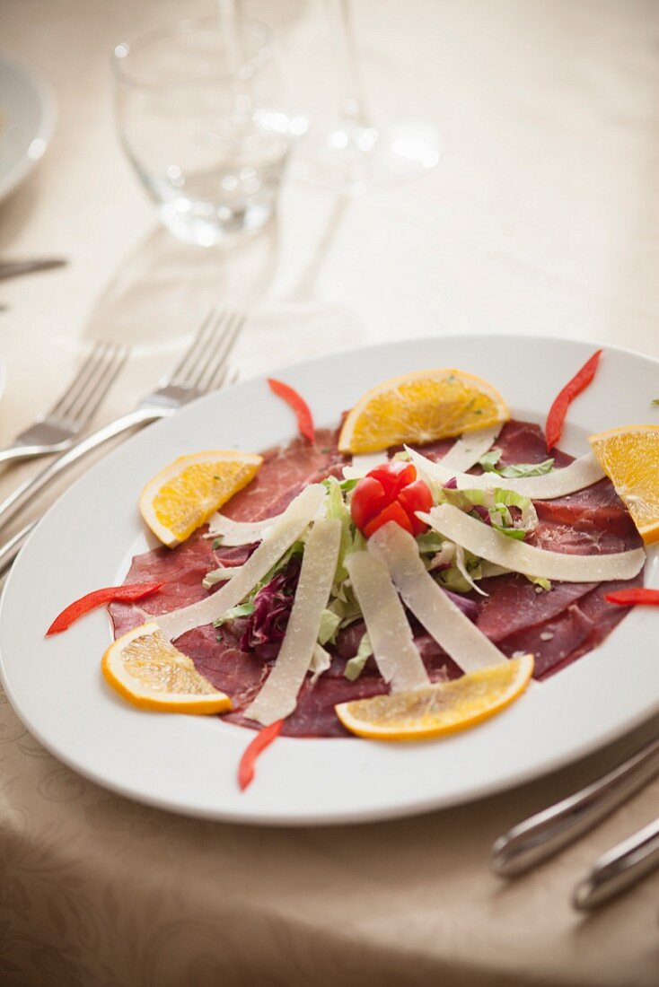 Bresaola with parmesan strips and orange slices