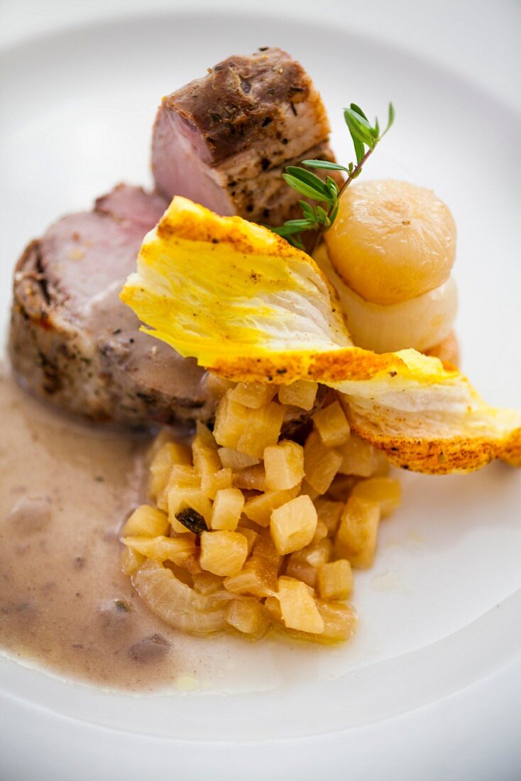 Pork fillet with apples, borettane onions and a saffron puff pastry stick