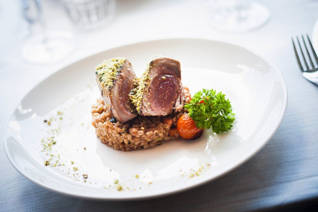Tuna in a pistachio crust on a bed of spelt and vegetables
