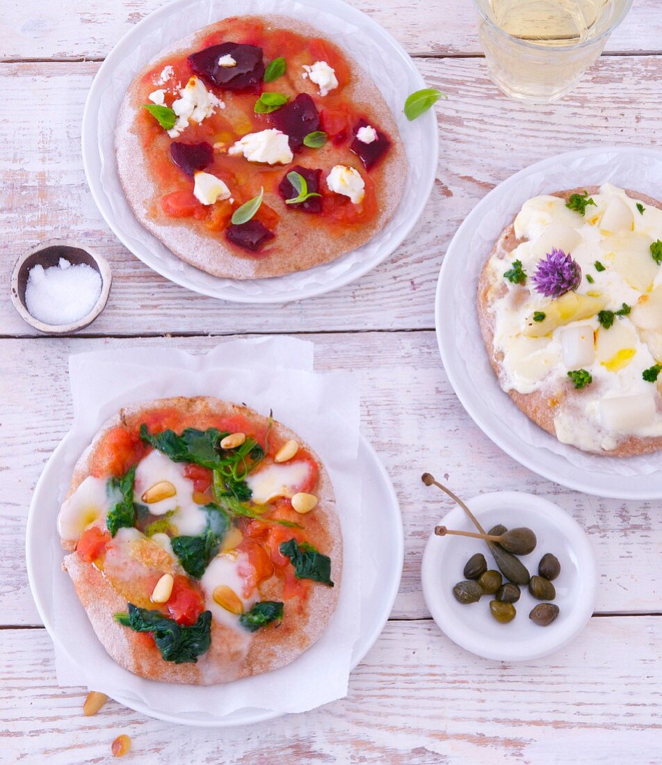 Three Assorted Pizzas;Pepperoni and Olive, Prosciutto Salad, Mozzarella and Basil; From Above