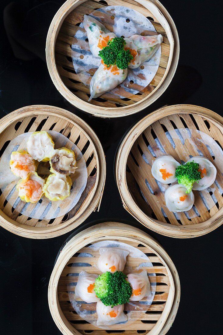 Various Chinese steamed dumplings in bamboo steaming baskets