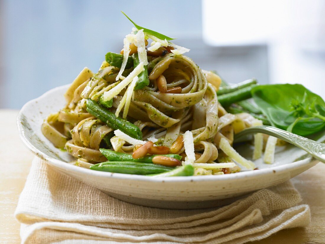 Linguine with beans, pesto and pine nuts