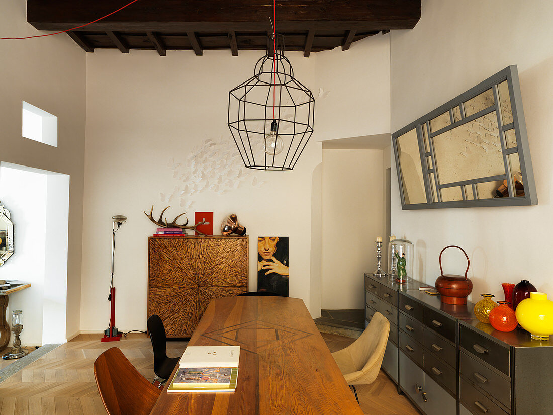 Wooden table and metal sideboard in designer dining room