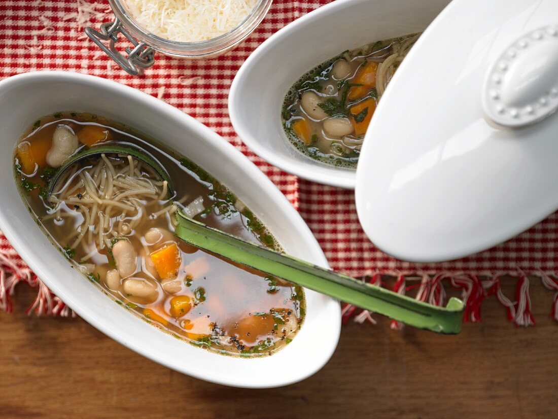 Italian noodle and bean stew with bacon and carrot