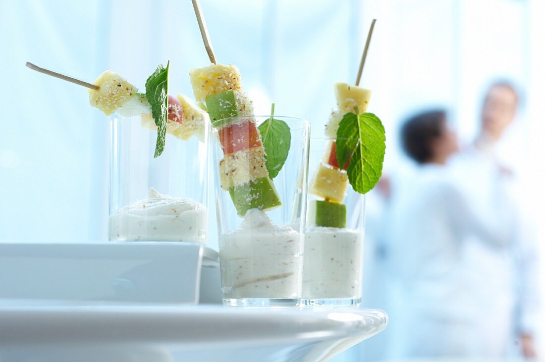 Fruit skewers with coconut yoghurt in glasses