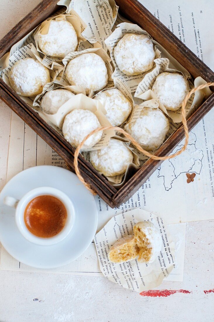 Walnut cookies covered in icing sugar and served with an espresso