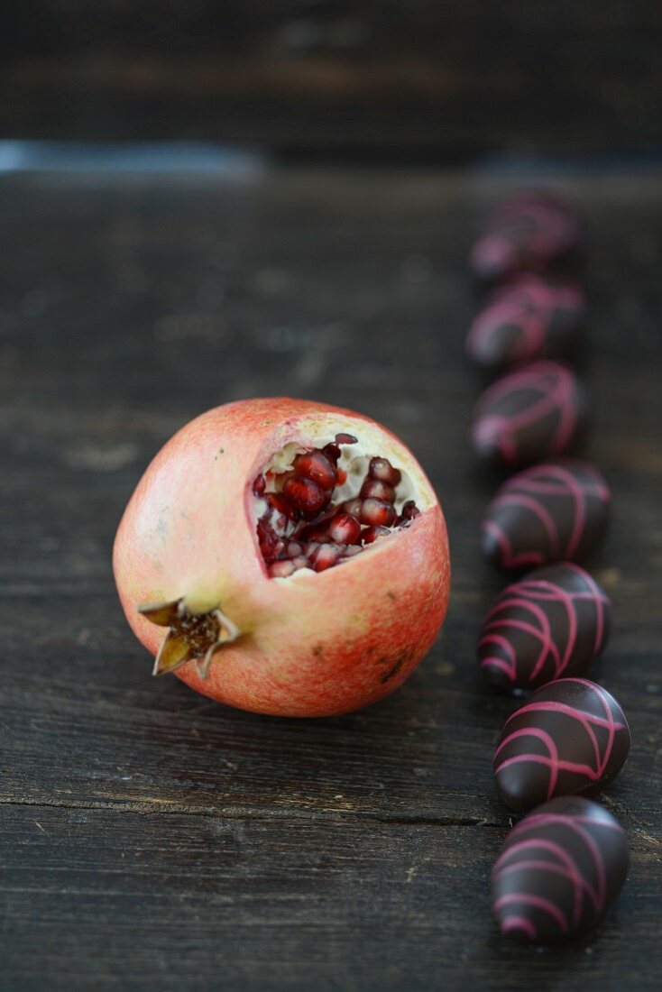 Cut pomegranate and chocolate eggs
