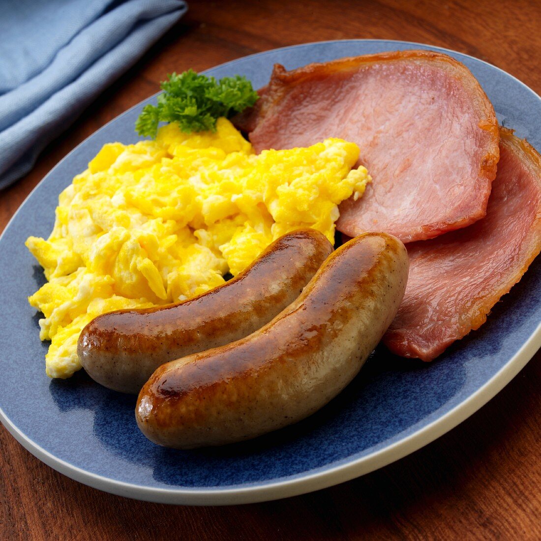 Scrambled eggs with two bangers and two English bacon